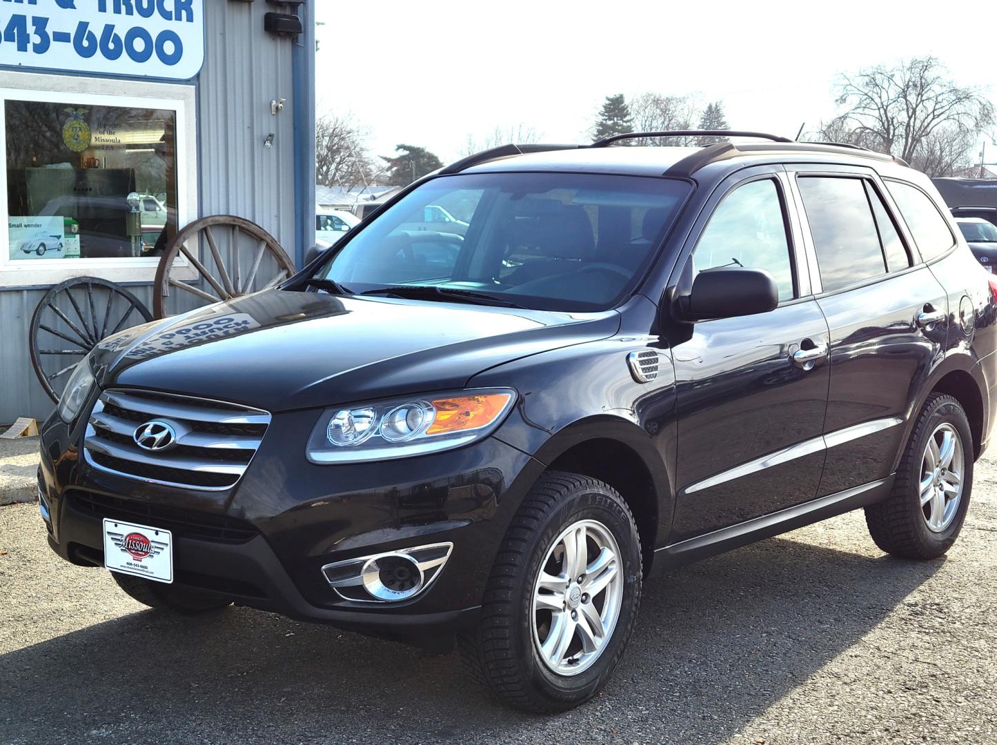 2012 Black /Tan Hyundai Santa Fe Premium (5XYZGDAB1CG) with an 2.4L I4 engine, 8 Speed Automatic transmission, located at 450 N Russell, Missoula, MT, 59801, (406) 543-6600, 46.874496, -114.017433 - NICE AWD SUV. Automatic Transmission. Air. Cruise. Tilt. Power Windows and Locks. AM FM XM Cd Player. Bluetooth. Two Sets of Tires. Studded Snow Tires are currently on. - Photo#3